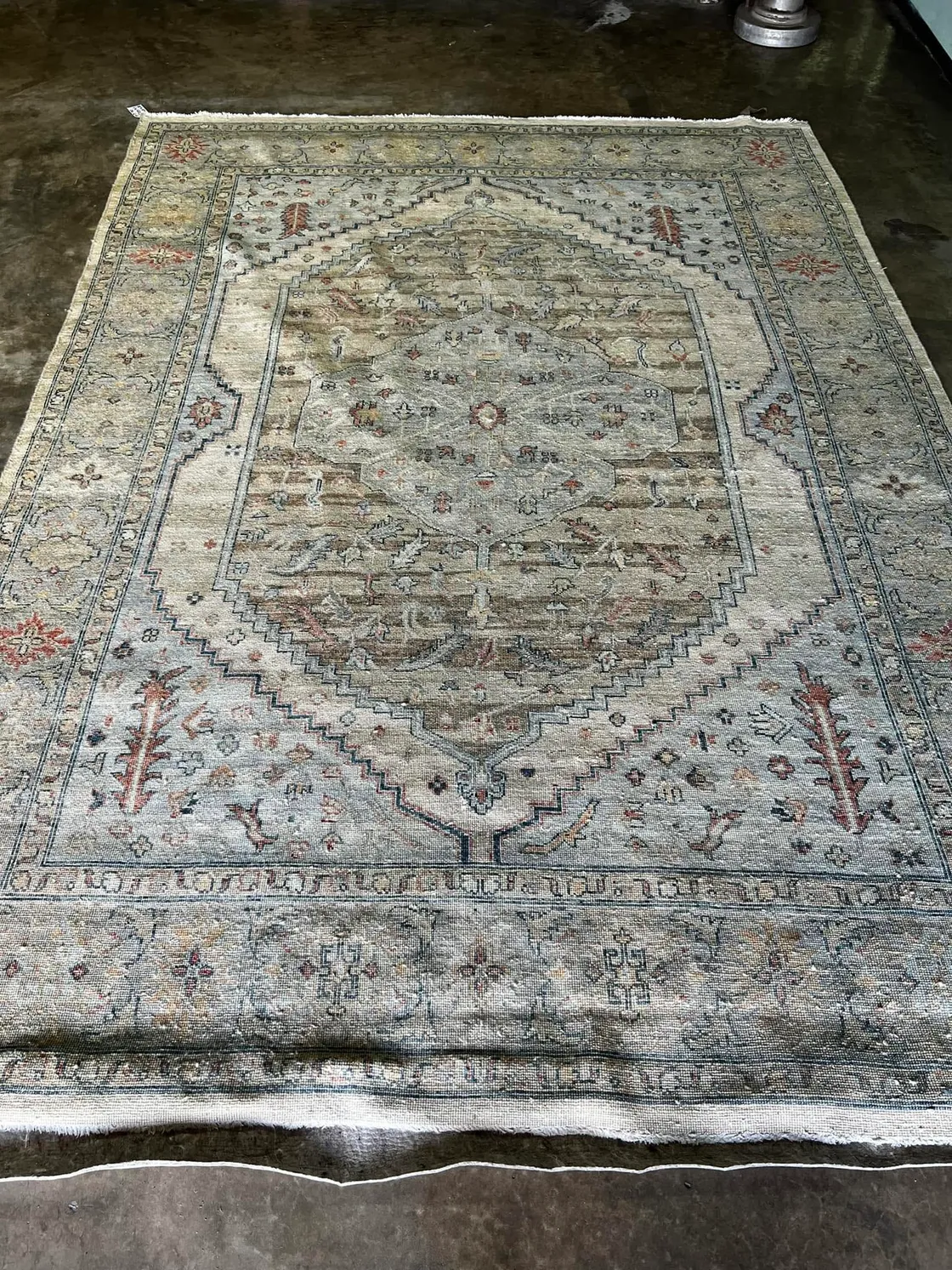 A freshly hand-washed antique Persian rug on the plant floor in Sarasota