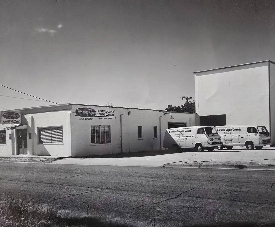 The plant at 825 N Lime Ave decades ago — Sarasota Carpet Cleaning Company signage on the building and two original delivery vans parked outside